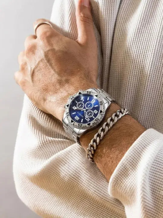 Hombre con reloj plateado de esfera azul y brazalete